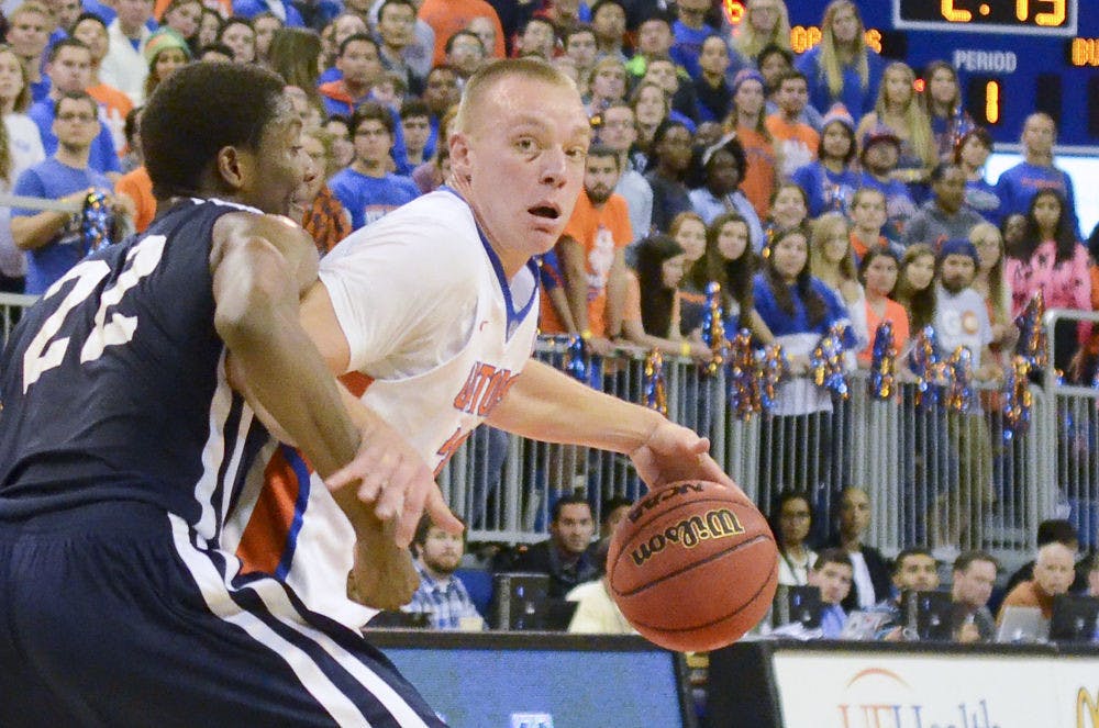 Jacob Kurtz dribbles the ball during Florida’s 85-47 win against Yale in the O’Connell Center.&nbsp;