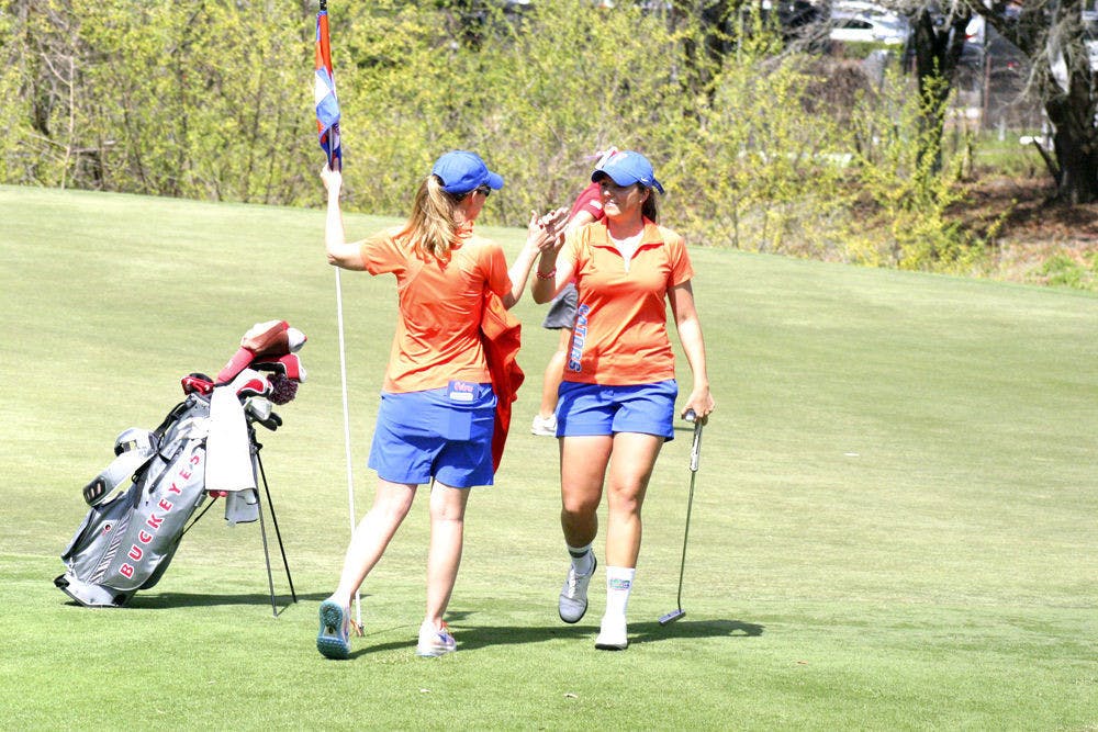 Karolina Vlckova (right) celebrates with coach Emily Glaser during the 2015 Suntrust Gator Invitational at the Mark Bostick Golf Course in Gainesville.