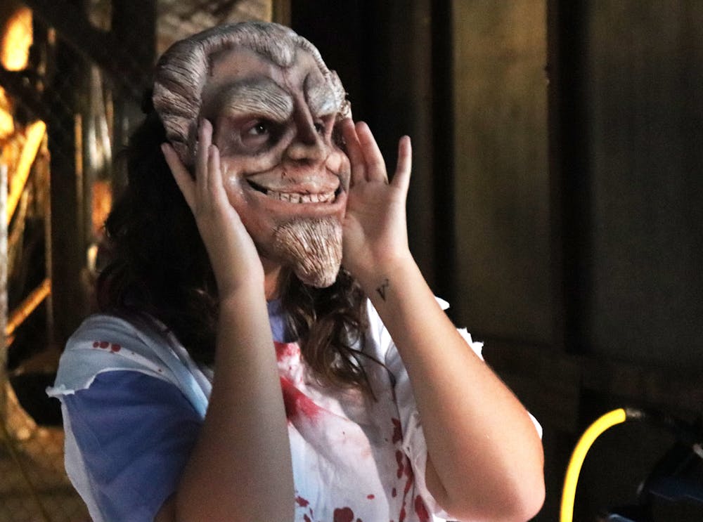Vanessa Garcia adjusts her mask to scare participants at the Gainesville Fear Garden on Sunday, Oct. 1, 2023. 
