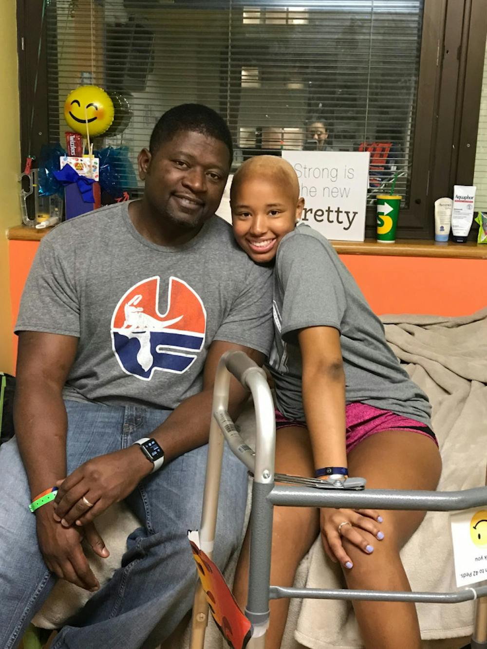 <p>Lauren Evans sits with her father, Jerome, at UF Health Shands, where she was receiving cancer treatment. Currently cancer free, Evans attempted to break the selfie world record Sunday after the Florida soccer team's win over LSU in effort to raise awareness for pediatric cancer.   </p>