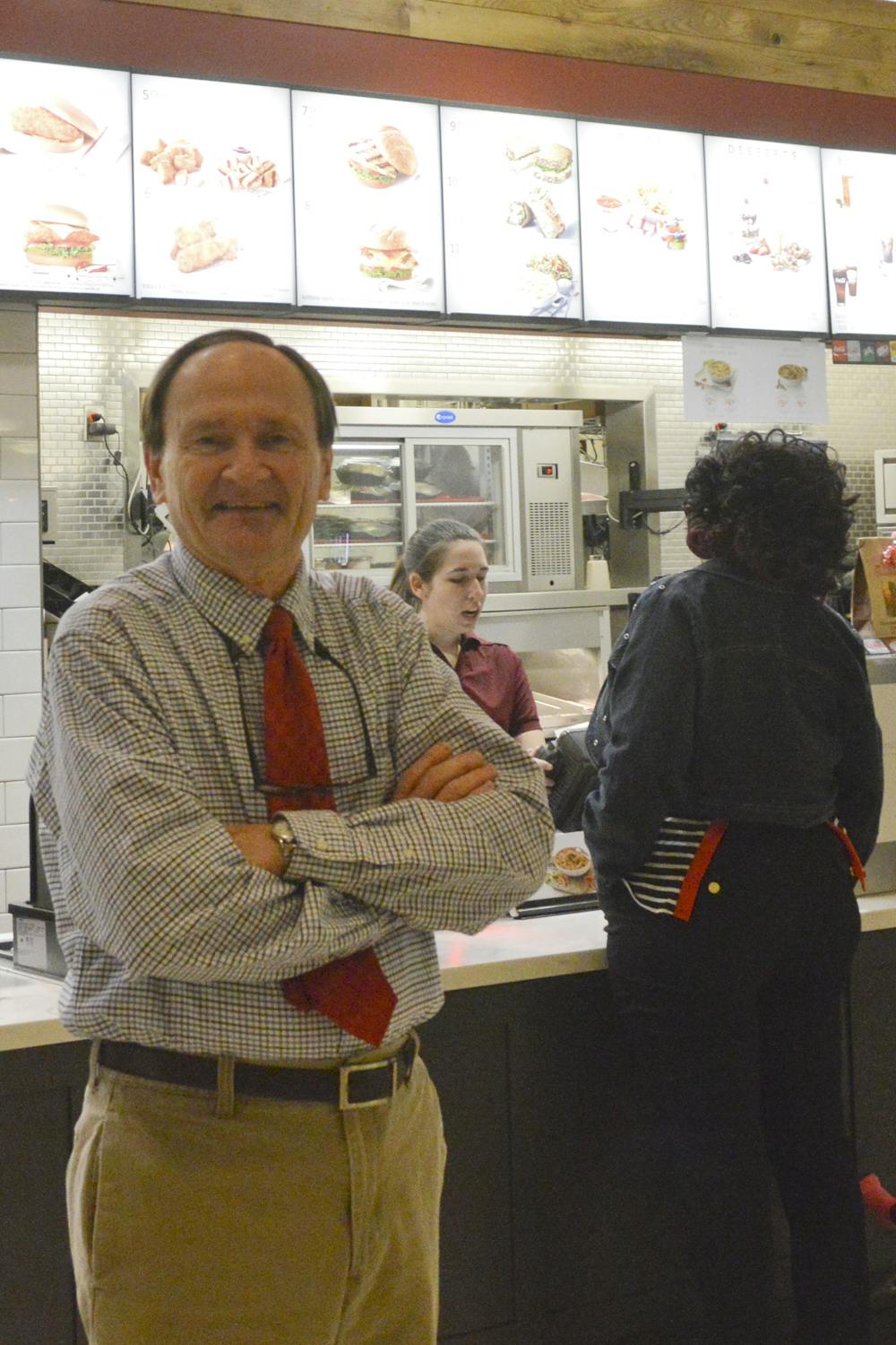 <p>Steve Carroll, owner of the Oaks Mall’s last locally owned store, stands in Chick-fil-a and poses for a picture. Carroll’s restaurant opened in 1978 and was one of the mall’s original stores.</p>
