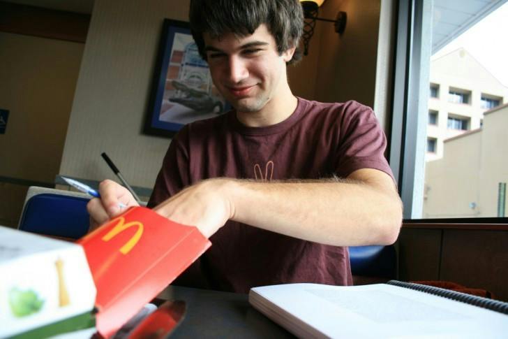 Hunter Nichols, a 20-year-old English sophomore, studies while he eats at the McDonald's at 201 NW 13th St. on Tuesday afternoon.