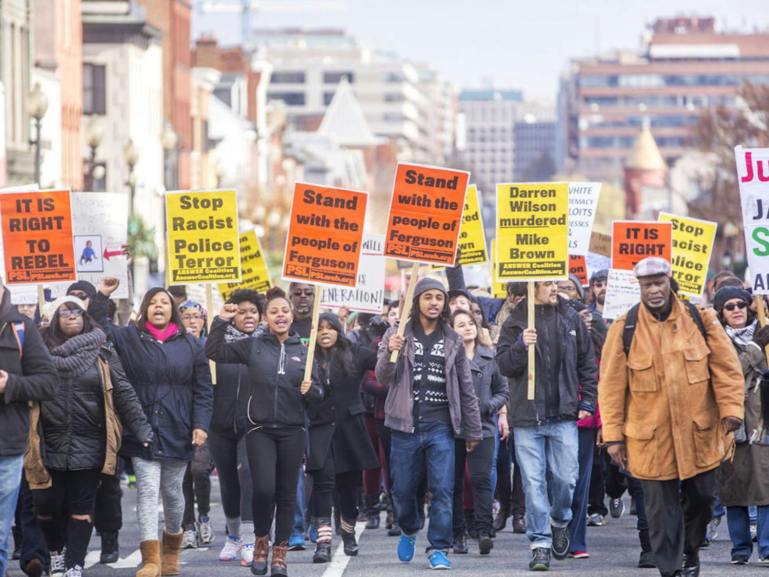 Some of the several hundred demonstrators marching down M Street in Georgetown Saturday afternoon towards the key bridge. The protest focused on Michael Brown's death and the recent grand jury decision in Ferguson. during a Ferguson Protest in Georgetown, DC, Saturday, Nov. 29, 2014. (AP Photo/Erin Schaff)