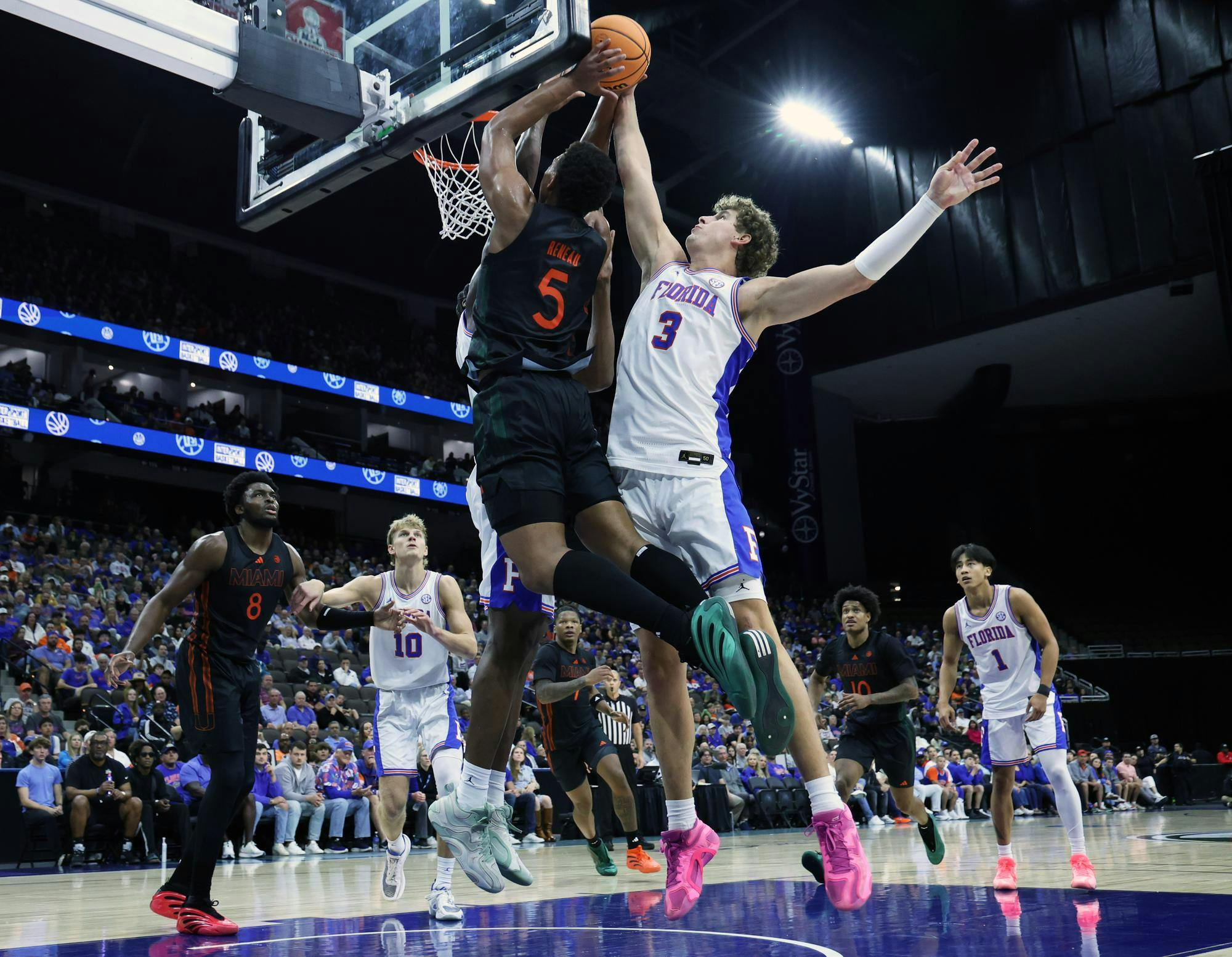 Florida's Micah Handlogten blocks Miami's Malik Reneau from scoring during the Jacksonville Hoops Showdown at VyStar Veterans Memorial Arena in Jacksonville, Fla., on Sunday, Nov. 16, 2025.