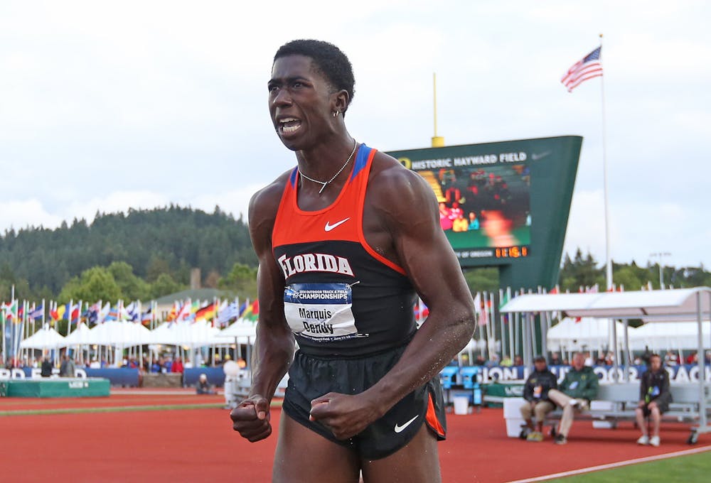 <p>Florida's Marquis Dendy reacts after competing in the long jump at the 2014 NCAA track and field championships on Thursday in Eugene, Oregon.</p>