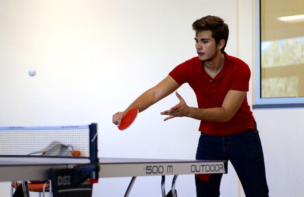 Esteban Siles, an 18-year-old industrial engineering freshman, plays a game of table tennis with his friend Carlos Ancaten in the recently opened Reitz Union Game Room on Tuesday afternoon.