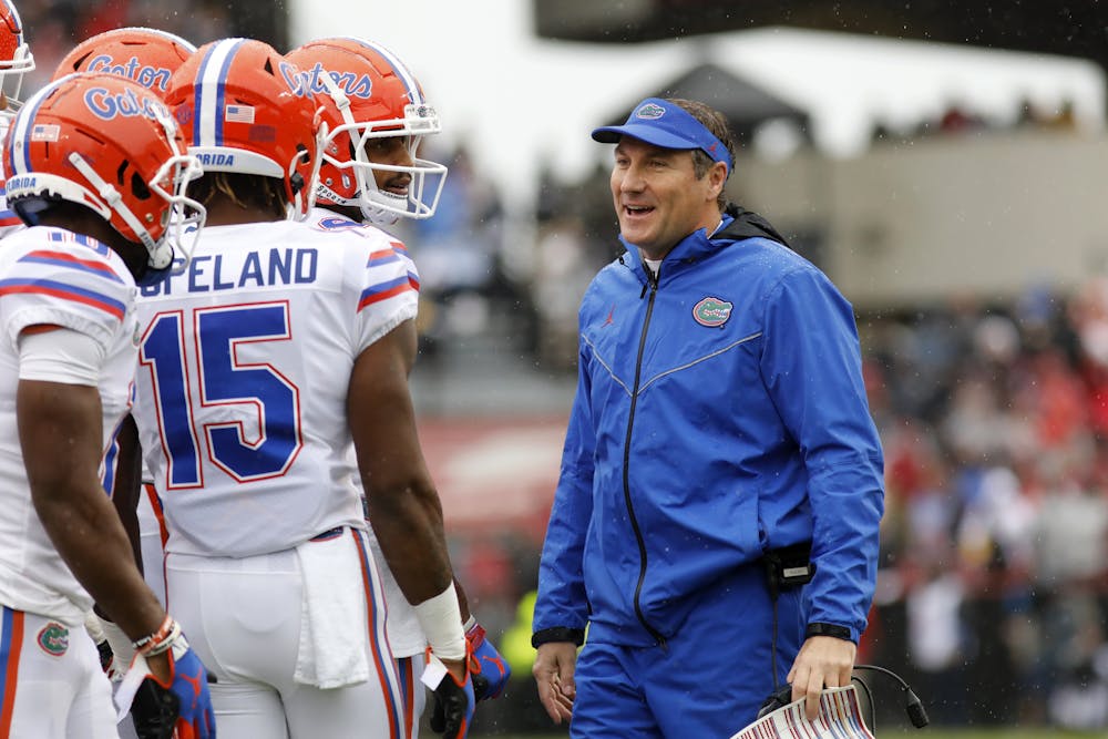 <p><span>Florida's head coach Dan Mullen smiles with his players during the first half of an NCAA college football game against South Carolina, Saturday, Oct. 19, 2019, in Columbia, SC.</span></p>