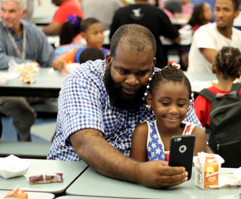 <p><span id="docs-internal-guid-a65a9dd0-7fff-6aa8-4325-bed7482bbacb"><span>Journey Lee and grandfather Cedric Lee enjoy breakfast together before school at Duval Early Learning Academy. The school hosted Dad’s Take Your Child To School Day on Wednesday, Sept. 26.</span></span></p>