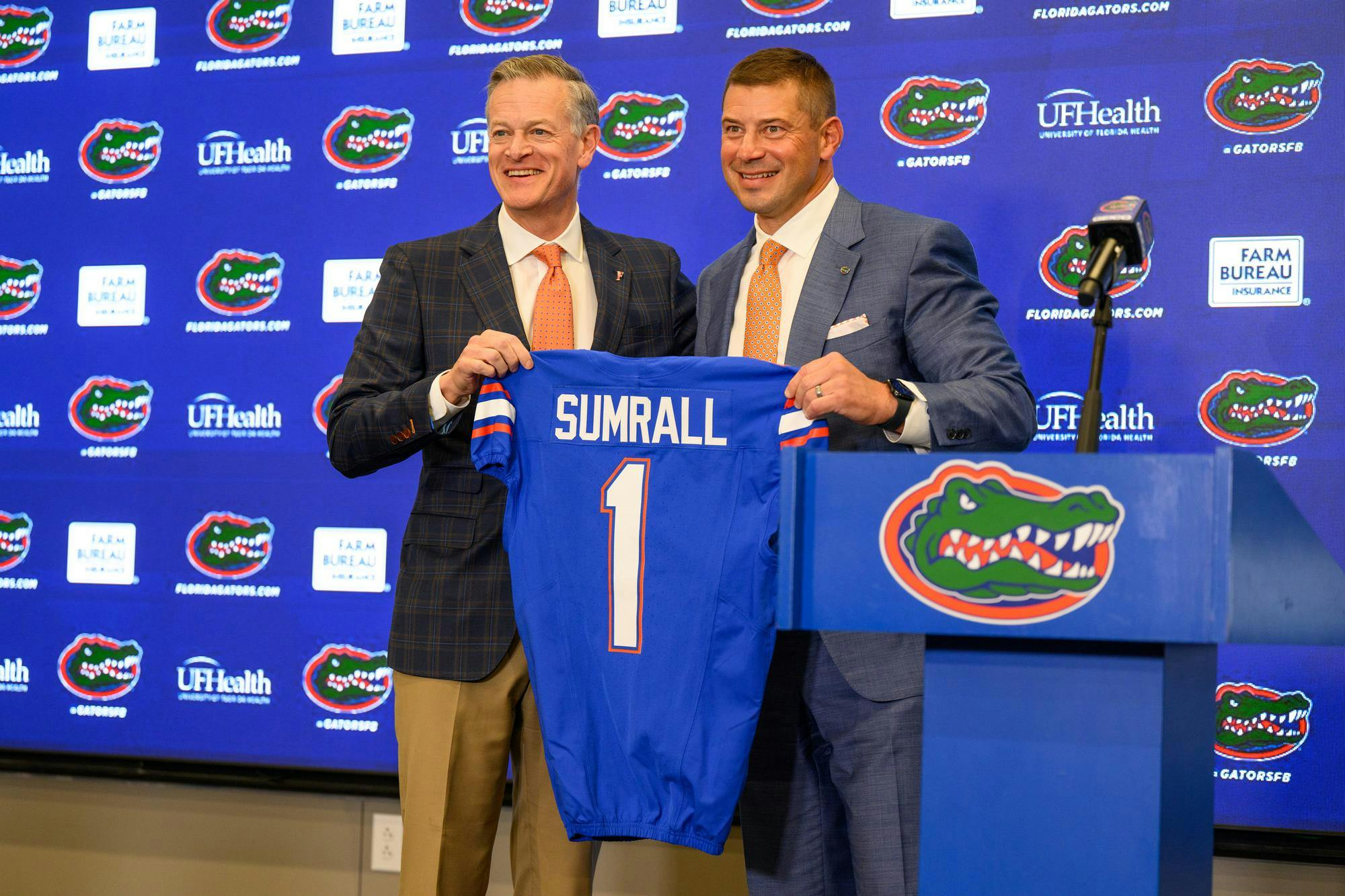 UF’s Athletics Director, Scott Stricklin, presents head coach Jon Sumrall with a jersey at his introductory press conference at Heavener Football Training Center in Gainesville, Fla., Monday, Dec. 1, 2025.
