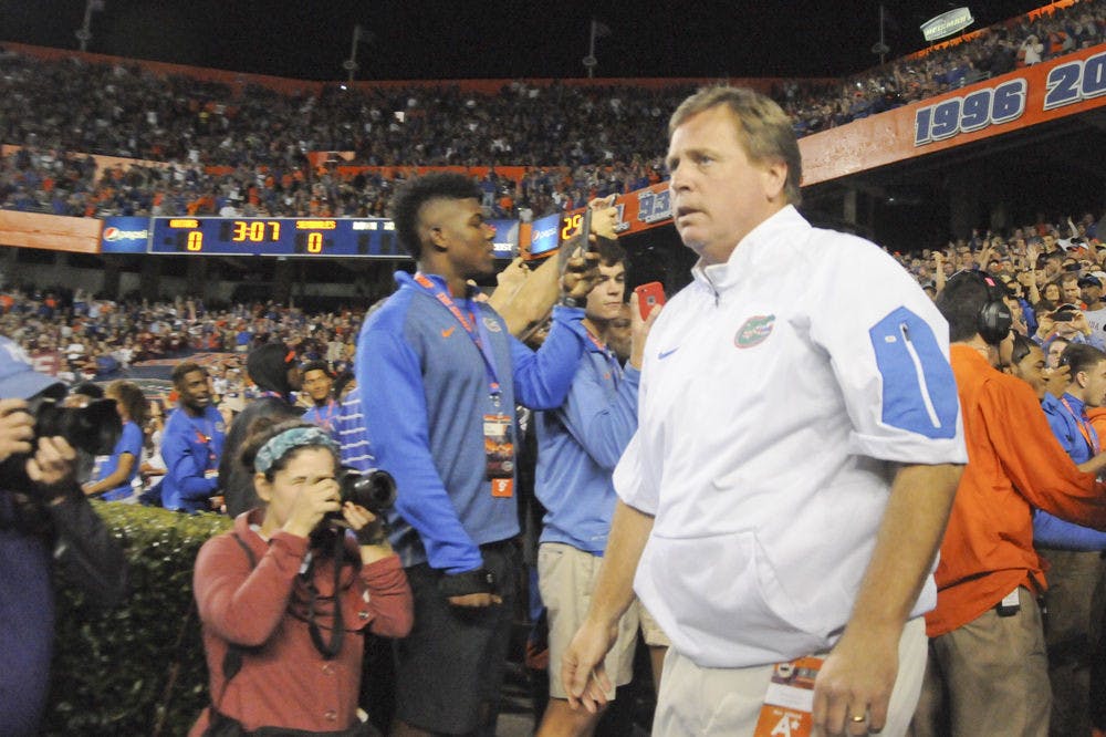 <p>UF coach Jim McElwain walks out of the tunnel prior to Florida's 27-2 loss to Florida State on Nov. 28, 2015, at Ben Hill Griffin Stadium.</p>