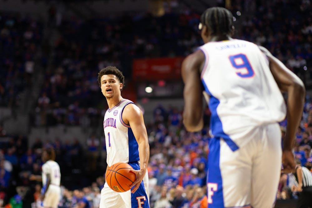 Florida Gators Guard Walter Clayton Jr. (1) calls out a play to Florida Gators Center Rueben Chinyelu (9) during the first half against the Virginia Cavaliers at Exactech Arena at the Stephen C. O'Connell Center on Wednesday, Dec. 4, 2024.