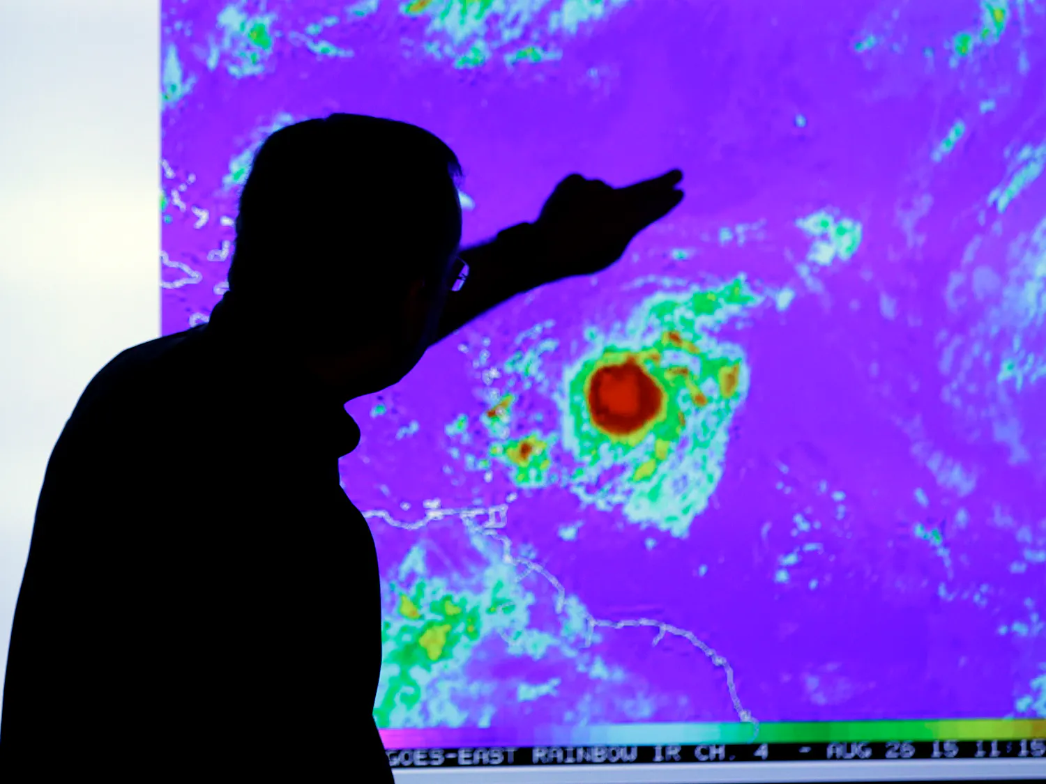 James Franklin, chief hurricane forecaster, looks at an image of Tropical Storm Erika as it moves westward towards islands in the eastern Caribbean, at the National Hurricane Center, Wednesday, Aug. 26, 2015, in Miami.