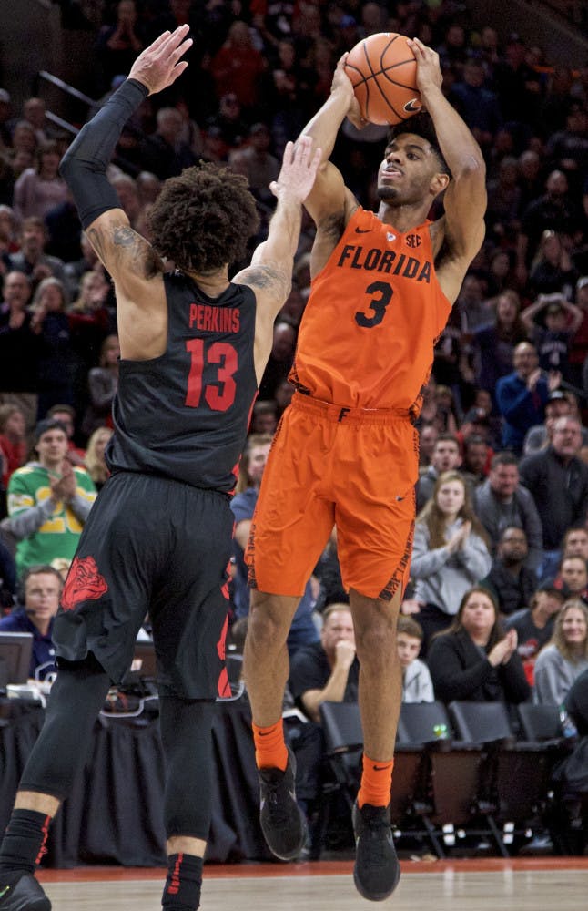 Florida guard Jalen Hudson, right, shoots over Gonzaga guard Josh Perkins during the second half of an NCAA college basketball game in the Phil Knight Invitational tournament in Portland, Ore., Friday, Nov. 24, 2017. Florida won 111-105. (AP Photo/Craig Mitchelldyer)