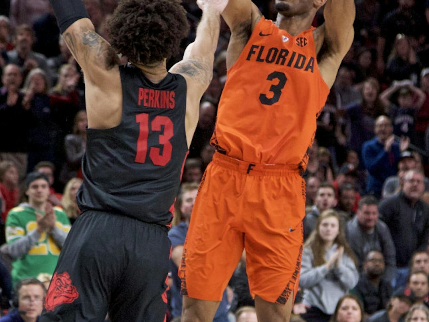 Florida guard Jalen Hudson, right, shoots over Gonzaga guard Josh Perkins during the second half of an NCAA college basketball game in the Phil Knight Invitational tournament in Portland, Ore., Friday, Nov. 24, 2017. Florida won 111-105. (AP Photo/Craig Mitchelldyer)