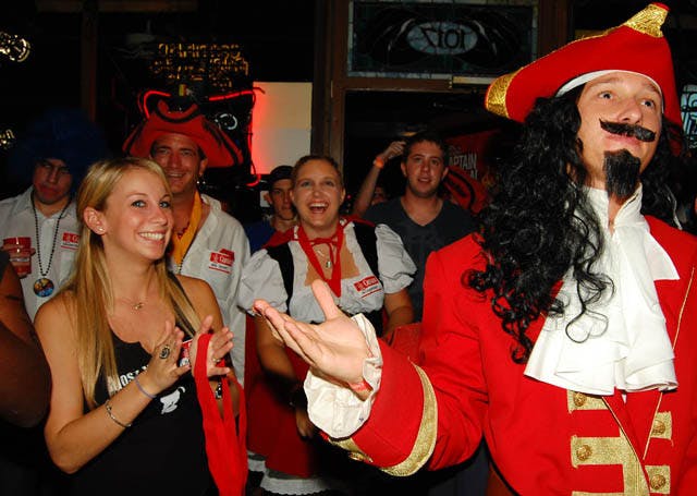 “The Captain” selects a winner for a Halloween costume contest at Mothers Pub and Grill on 1017 W. University Ave.