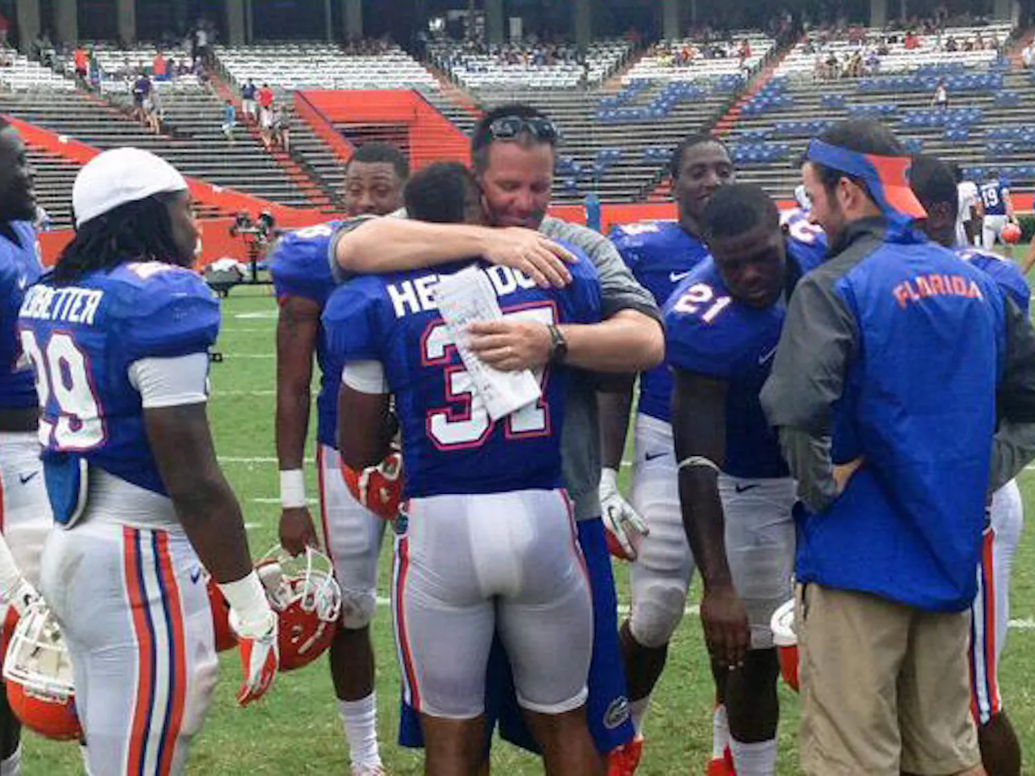 Running backs coach Brian White hugs sophomore running back Mark Herndon during Tuesday's practice at Ben Hill Griffin Stadium. Florida put Herndon and fifth-year safety Tim Clark, both previously walk-ons, on full scholarship Tuesday.