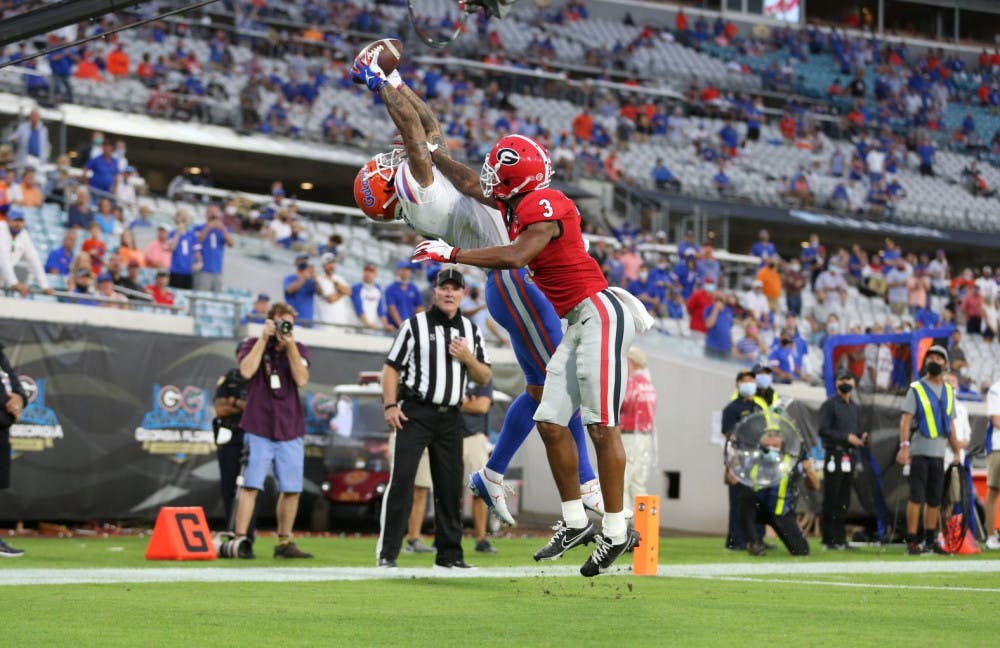 <p>Wide receiver Trevon Grimes stretches to catch the football ball thrown by Gators quarterback Kyle Trask and score a touchdown for Florida against Georgia at TIAA Bank Field on Nov. 7, 2020.</p>