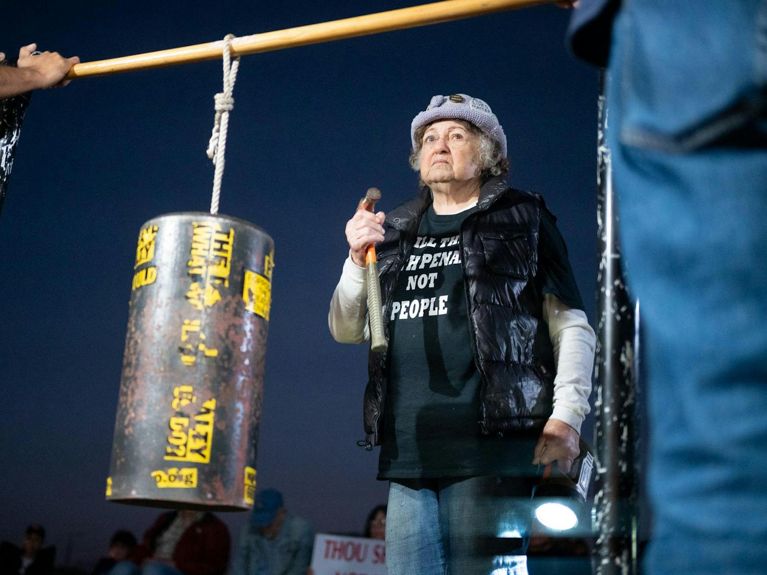 Helen Pajama, protester in opposition of Bryan Frederick Jennings’ execution, bangs a hammer on a metal cylinder in solidarity. Jennings was executed in Raiford on Thursday, Nov. 13, 2025.