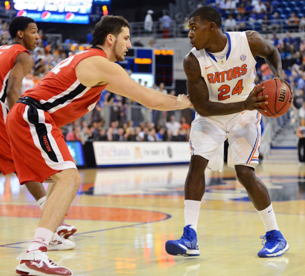 <p>Forward Casey Prather (24) looks for a scoring option against&nbsp; Georgia defender Nemanja Djurisic in Florida’s 77-44 win on Wednesday in the O’Connell Center. Prather scored 10 points in the victory.</p>