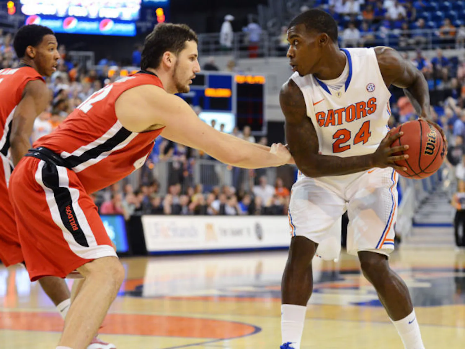 Forward Casey Prather (24) looks for a scoring option against Georgia defender Nemanja Djurisic in Florida’s 77-44 win on Wednesday in the O’Connell Center. Prather scored 10 points in the victory.