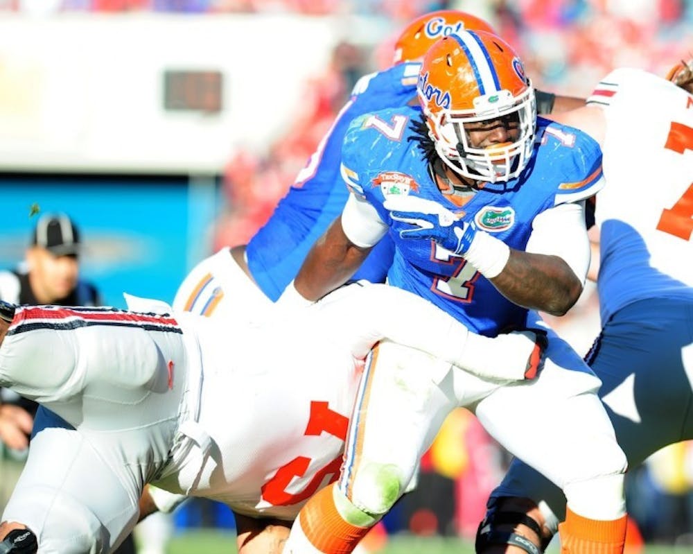 <p>Florida defensive end/linebacker Ronald Powell was one of five Gators to sack Buckeyes freshman quarterback Braxton Miller during Monday's Gator Bowl.</p>