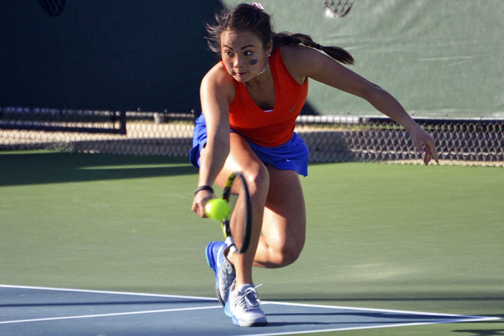 <p>Spencer Liang dives for a one-handed backhand during Florida's win against Elon.</p>