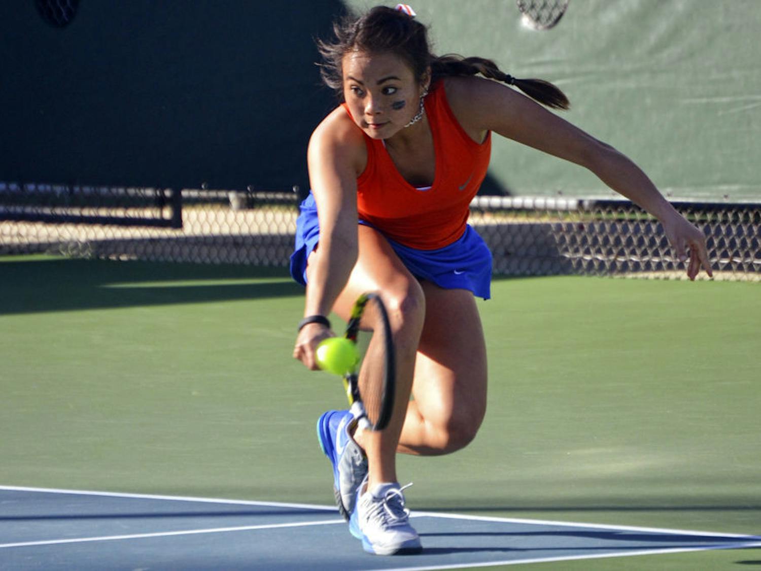 Spencer Liang dives for a one-handed backhand during Florida's win against Elon.