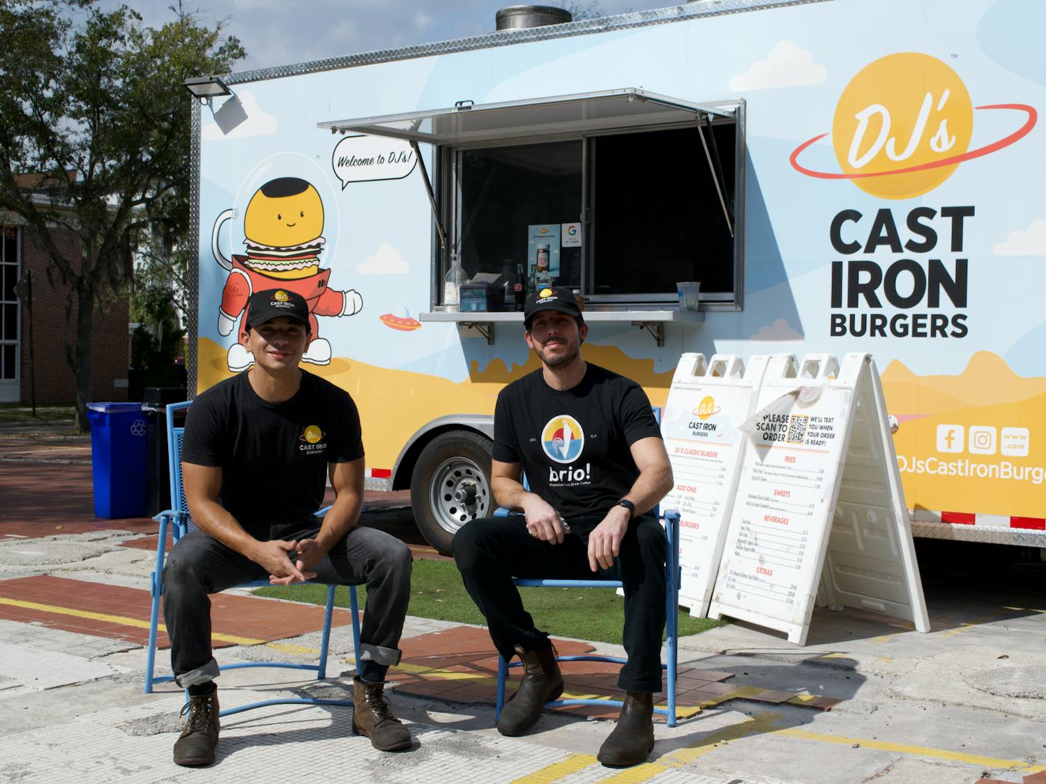 José Nieves and Miguel Cardona sit in front of their food truck in Gainesville.