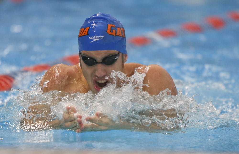 <p>Junior Matt Elliott competes in the men's open 100 breast at the Pinch a Penny All-Florida Invitation at the Stephen C. O'Connell Center on Sept. 28.</p>