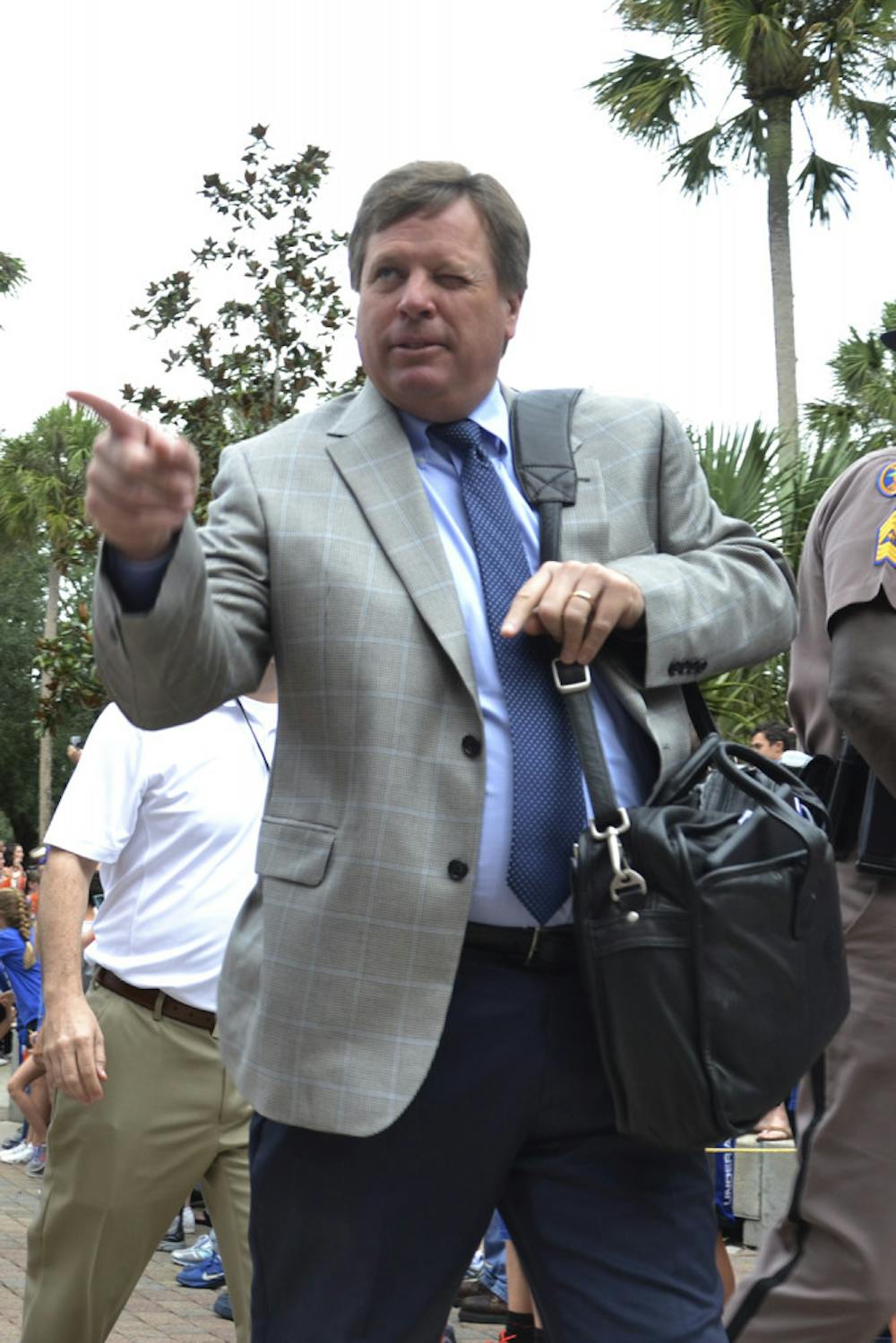 <p>UF coach Jim McElwain points to the crowd during Gator Walk prior to Florida's 20-14 overtime win against Florida Atlantic on Nov. 21, 2015.</p>