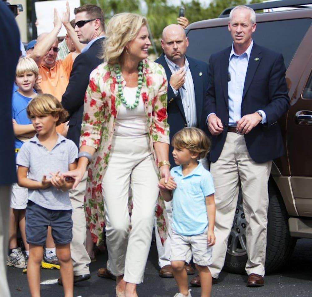 <p>Ann Romney walks with two of her grandchildren after greeting supporters at David’s Real Pit BBQ located on Northeast 23rd Avenue on Thursday afternoon.</p>