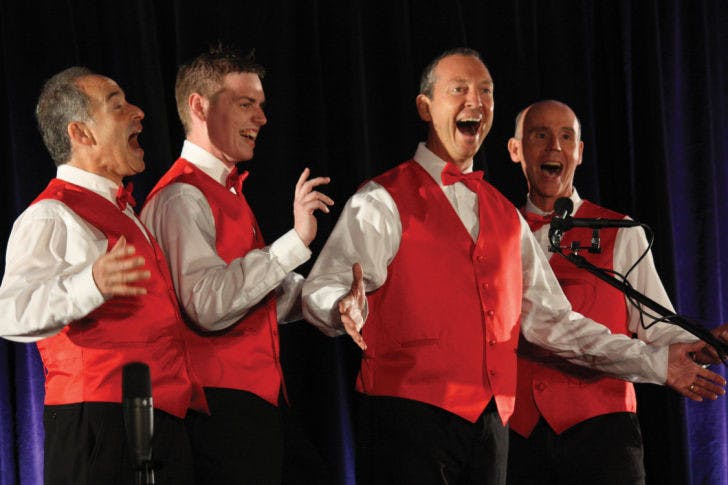 Mike Roth, 61, C.J. Shaw, 26, Tyson Adams, 46, and Bob Tucker, 57, the four members of FOURTUNATE, a Gainesville barbershop quartet, perform in a singing competition in Orlando on April 26.