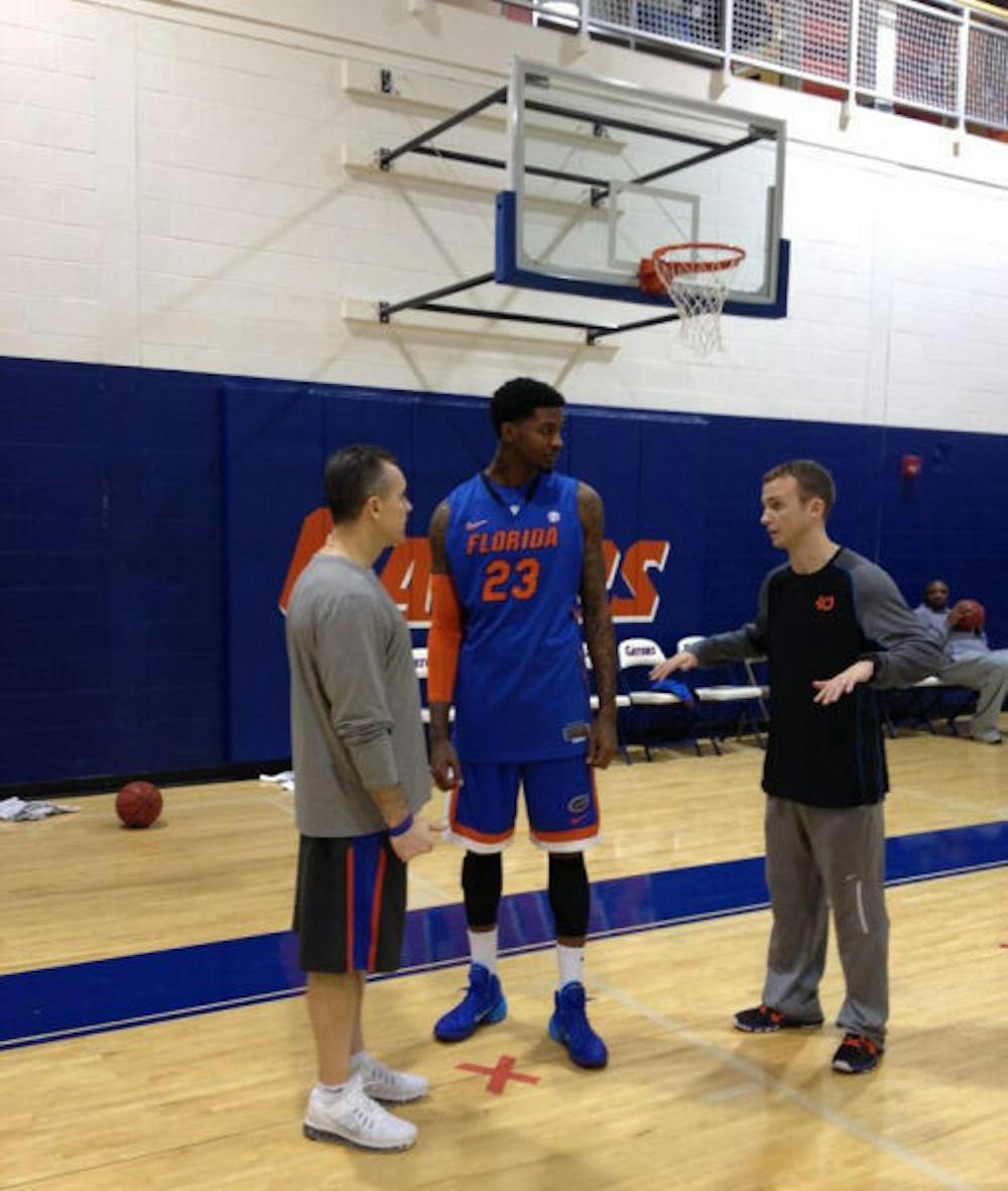 <p>On his first day practicing with the Gators, freshman forward Chris Walker (23) is greeted by coach Billy Donovan (left) and assistant coach Matt McCall on Saturday morning.</p>