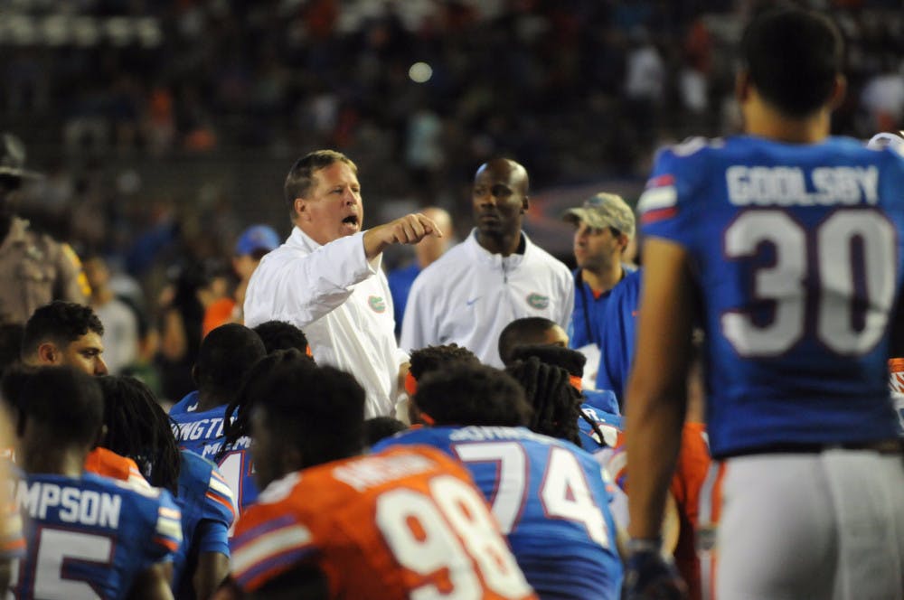 UF coach Jim McElwain talks with his team following the Orange &amp; Blue Debut on April 8, 2016, at Ben Hill Griffin Stadium.