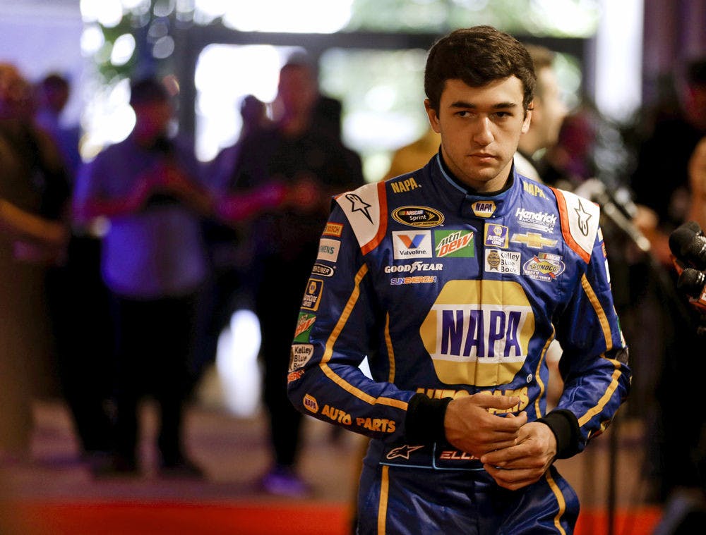 Chase Elliott walks to an interview during NASCAR media day at Daytona International Speedway, Tuesday, Feb. 16, 2016, in Daytona Beach, Fla. (AP Photo/John Raoux)
