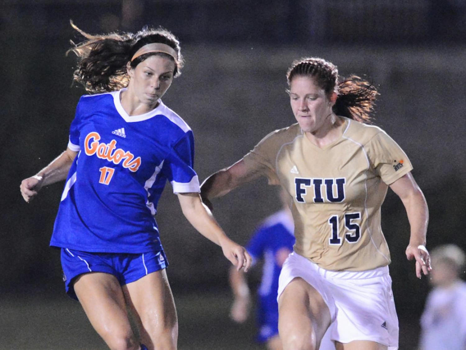 Erika Tymrak (17) battles with Crystal McNamara (15) of Florida International University during Florida's 3-0 win on Sept. 2 at James G. Pressly Stadium. Tymrak is one of three Florida seniors to earn All-Southeastern Conference first team. She also won SEC Offensive Player of the Year.