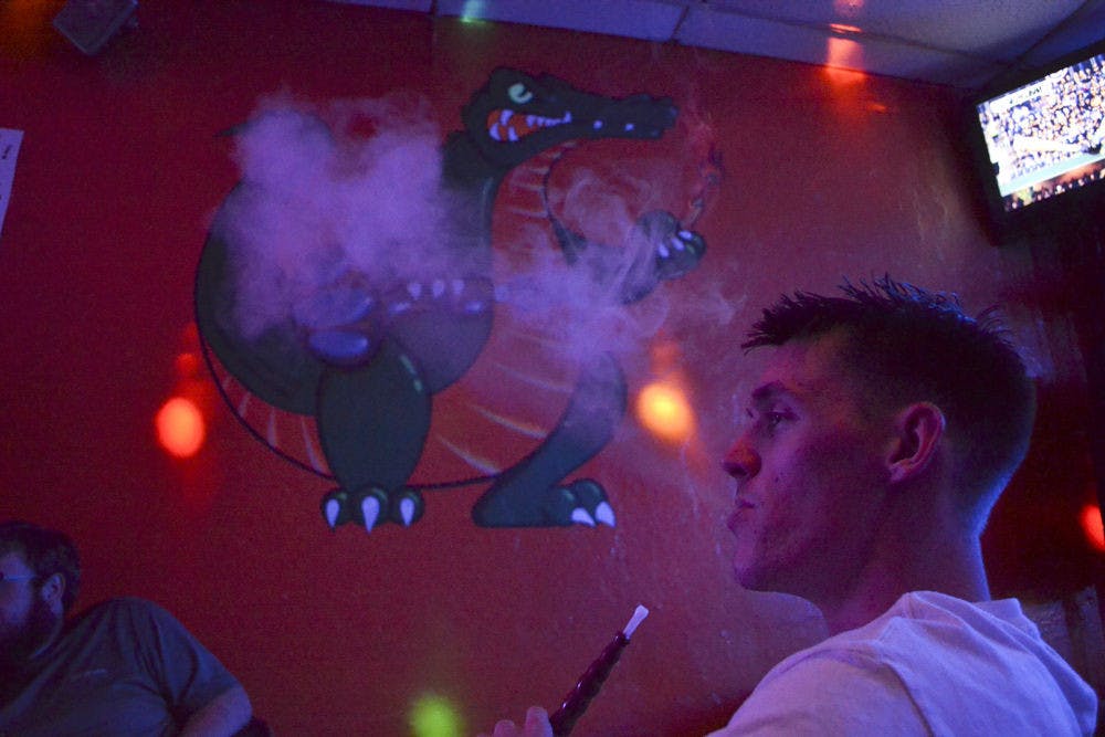 <p>Taylor Ratcliff, a 23-year-old who will return to UF as a history senior in the spring, blows out Gator Mist flavored smoke at Sheesha on Oct. 7, 2015. Ratcliff said he used smoke at Sheesha twice a week with friends, but hadn’t been back in a while because he purchased his own hookah.</p>