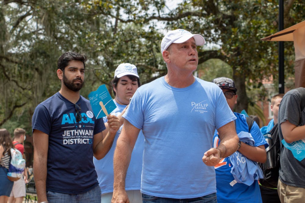 Philip Levine, 2018 gubernatorial candidate and former mayor of Miami Beach, speaks to a group of students gathered on the Plaza of the Americas on Wednesday afternoon. The UF College Democrats hosted the event. 