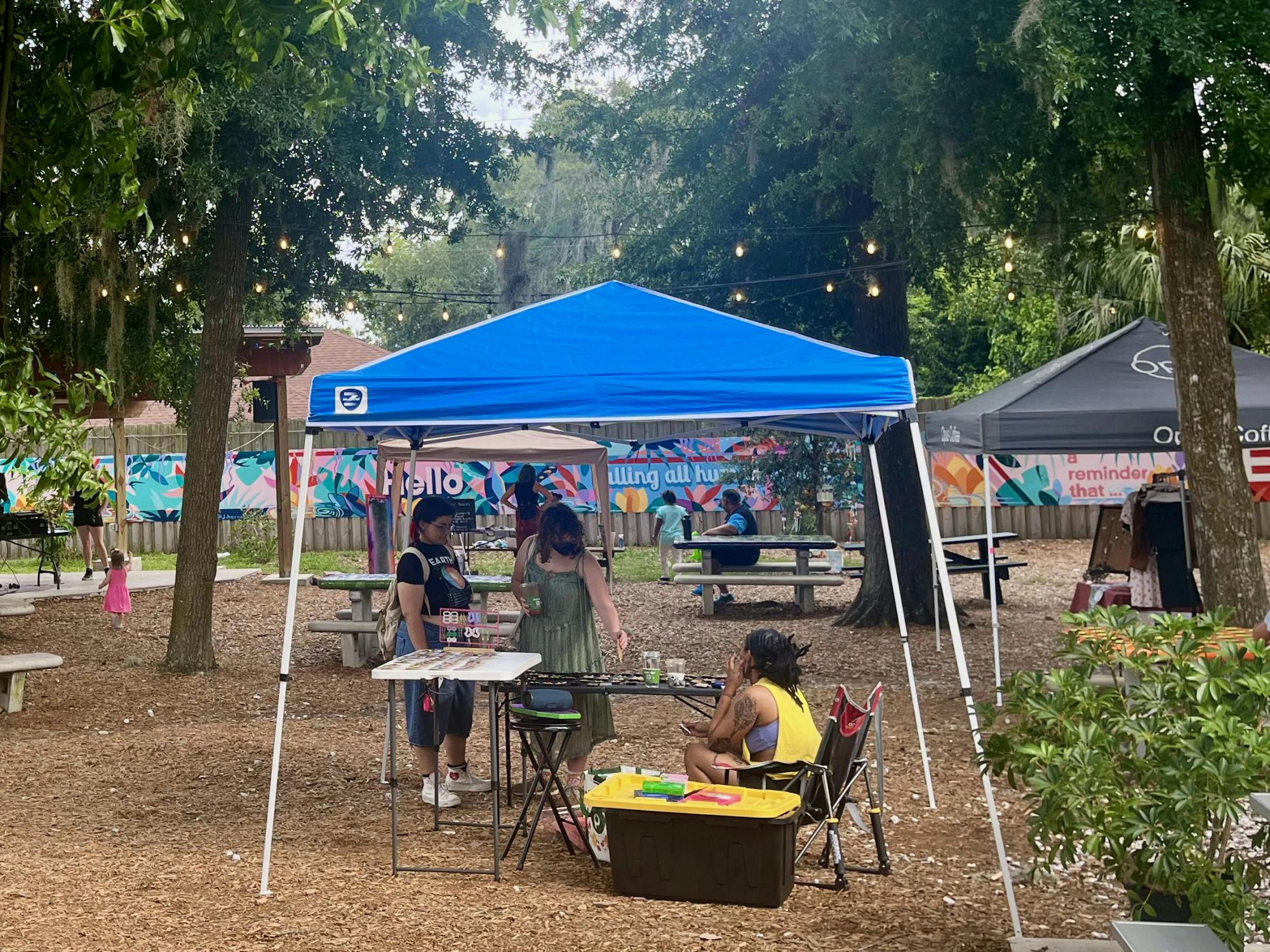 Market attendees explore the work of local artists at 4th Ave Food Park on Monday, June 19, 2023. 
