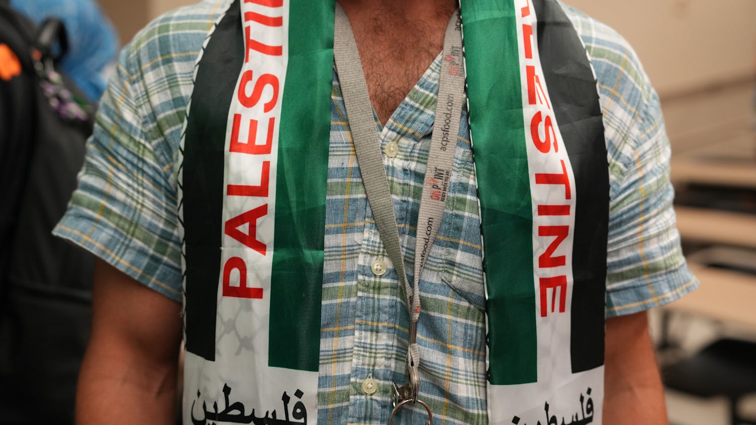 An attendee of UF SJP’s discussion in Turlington wearing a Palestine keffiyeh neck scarf on Thursday Oct. 12, 2023. 