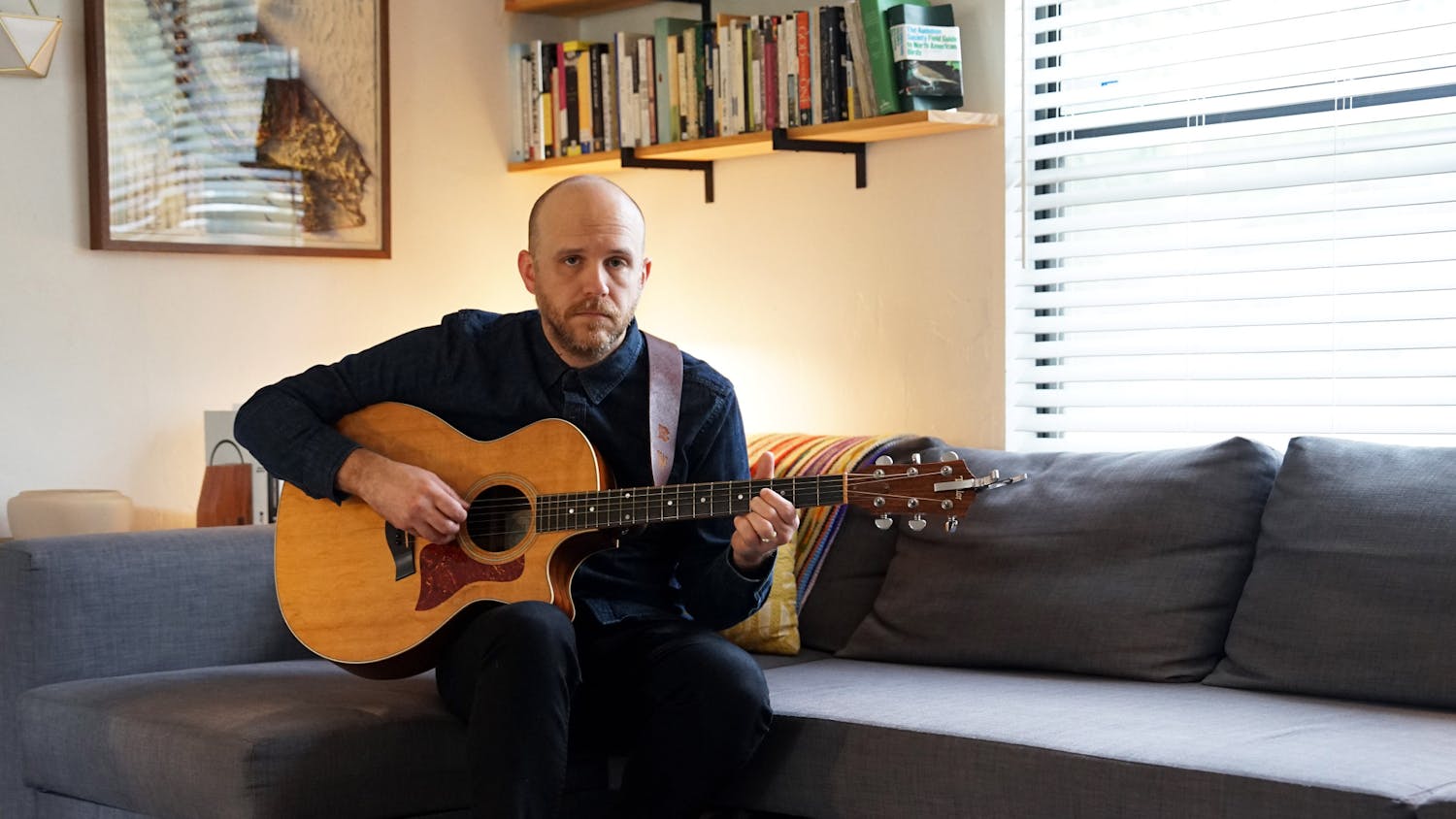 Musician Ben White poses with his guitar in his home in Gainesville, Fla., on Sunday, Aug. 20, 2023. 