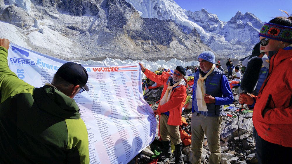 Standing on Mt. Everest, the group of climbers for Everest to End Duchenne, led by Tanya Dreher, post the Hope-Memory flag with the names of 750 boys and girls who had or have Duchenne Muscular Dystrophy, a terminal, degenerative disorder without a cure.