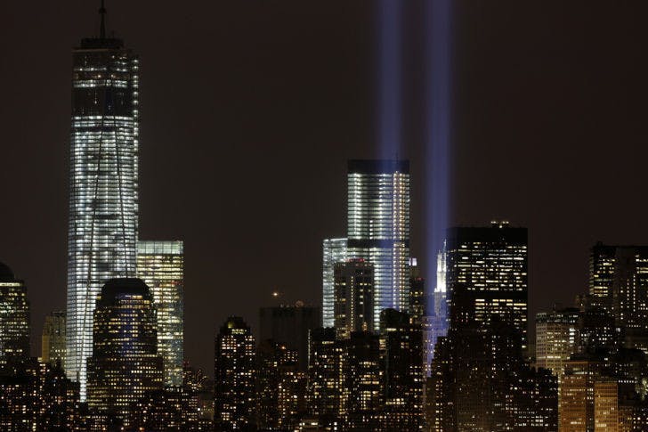 The Tribute in Light rises above the lower Manhattan skyline and Four World Trade Center, center, and One World Trade Center, left, in a test of the memorial light display, Monday, Sept. 9, 2013 in New York. The twin beams of light will also appear Wednesday, Sept. 11, twelve years after the terrorist attacks of Sept. 11, 2001. (AP Photo/Mark Lennihan)