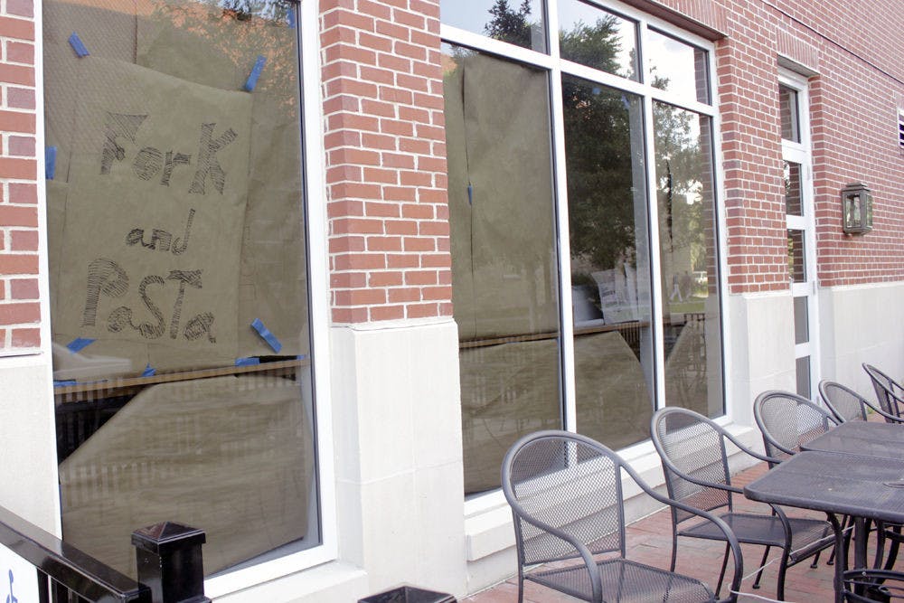 <p>A paper sign hangs in the window of Fork and Pasta at 1802 W University Ave. on Wednesday.</p>