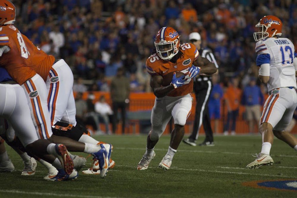 <p>UF running back Jordan Scarlett carries the ball during Florida's Spring game on Friday night at Ben Hill Griffin Stadium.</p>