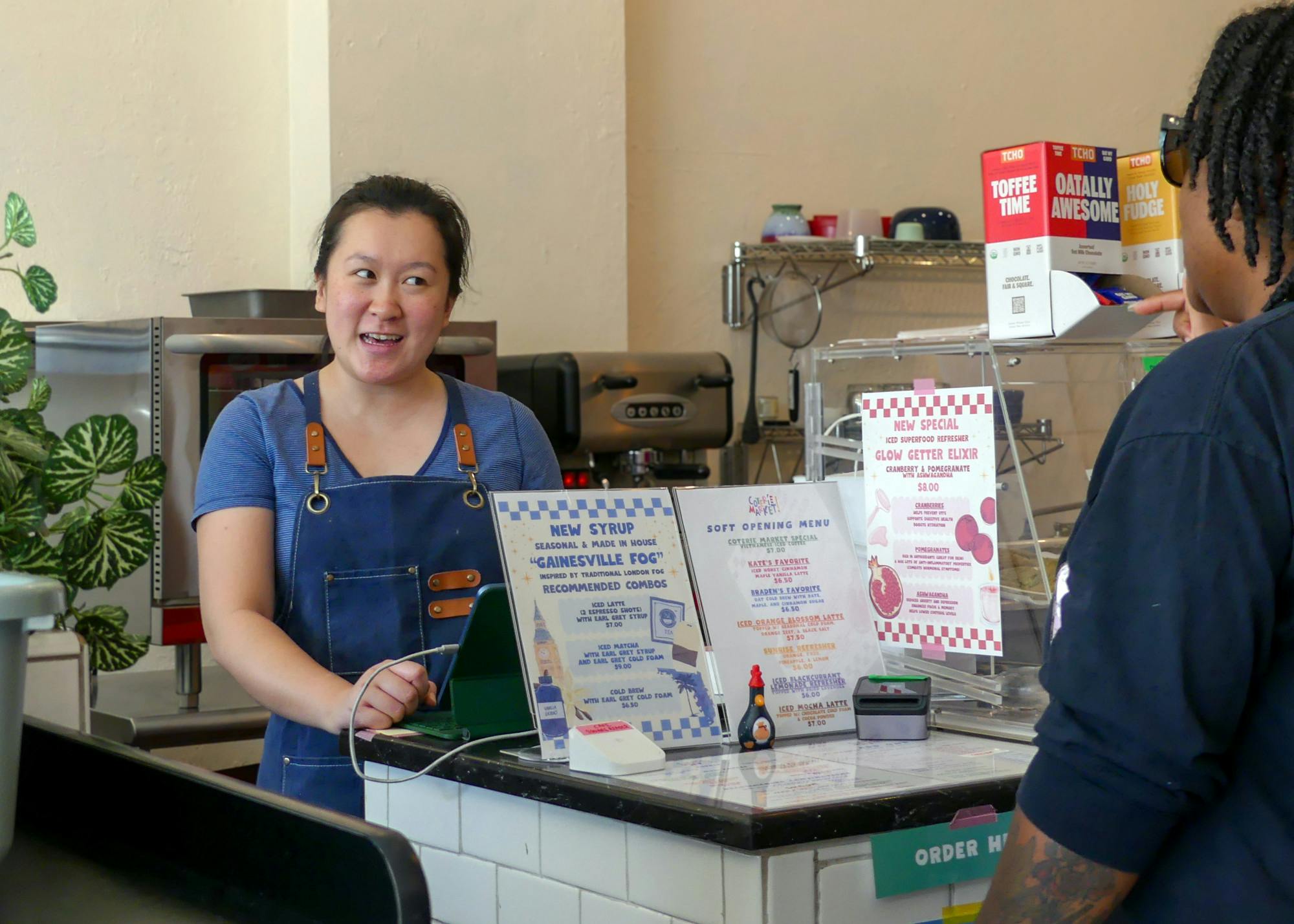 Kate Yeung, a co-owner of Coterie Market, helps customers on Sunday, July 13, 2025.
