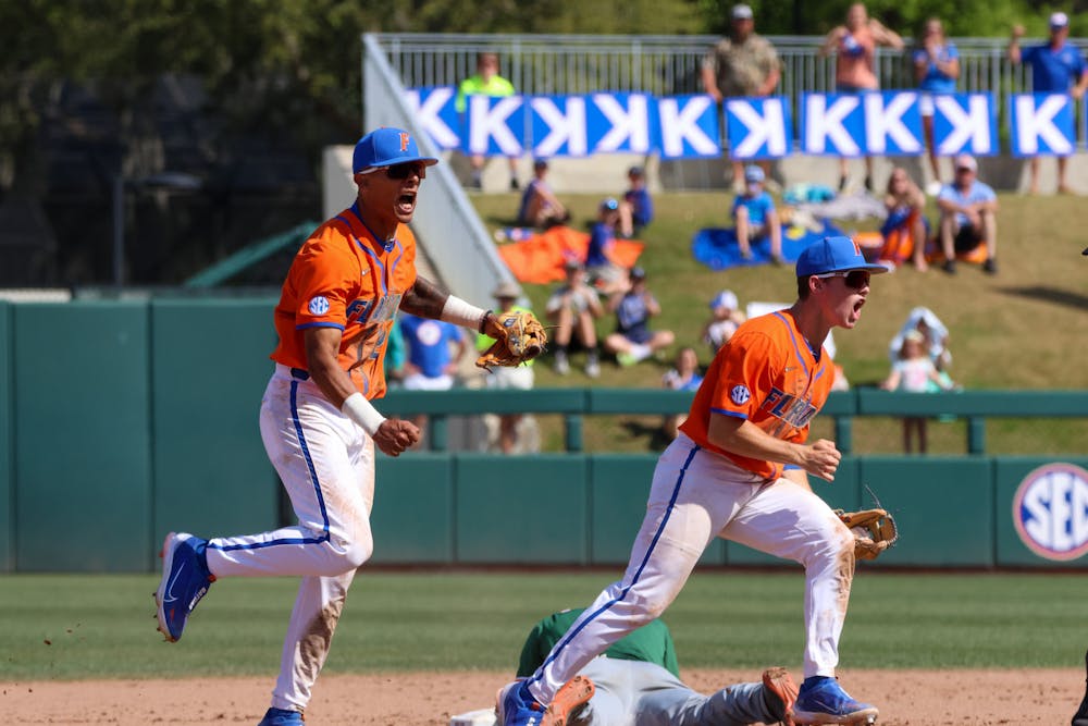 Florida infielders Josh Rivera and Cade Kurland celebrate an out in No. 6 Florida’s 14-4 mercy-rule win against the No. 22 Miami Hurricanes at Condron Ballpark Sunday, March 5, 2023
