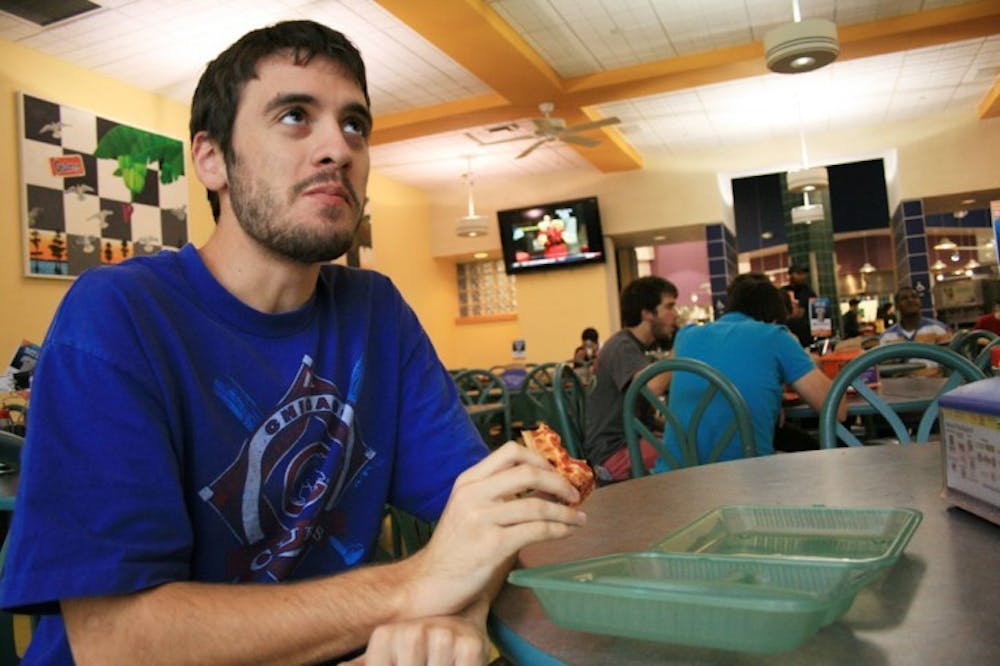 <p>Chas Hackmann, a 19-year-old mechanical engineering sophomore, uses a green to-go box every day at Gator Dining.</p>