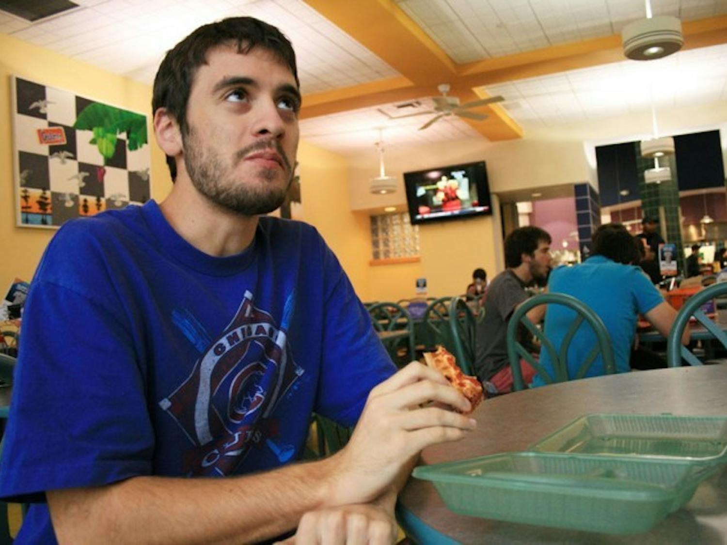Chas Hackmann, a 19-year-old mechanical engineering sophomore, uses a green to-go box every day at Gator Dining.