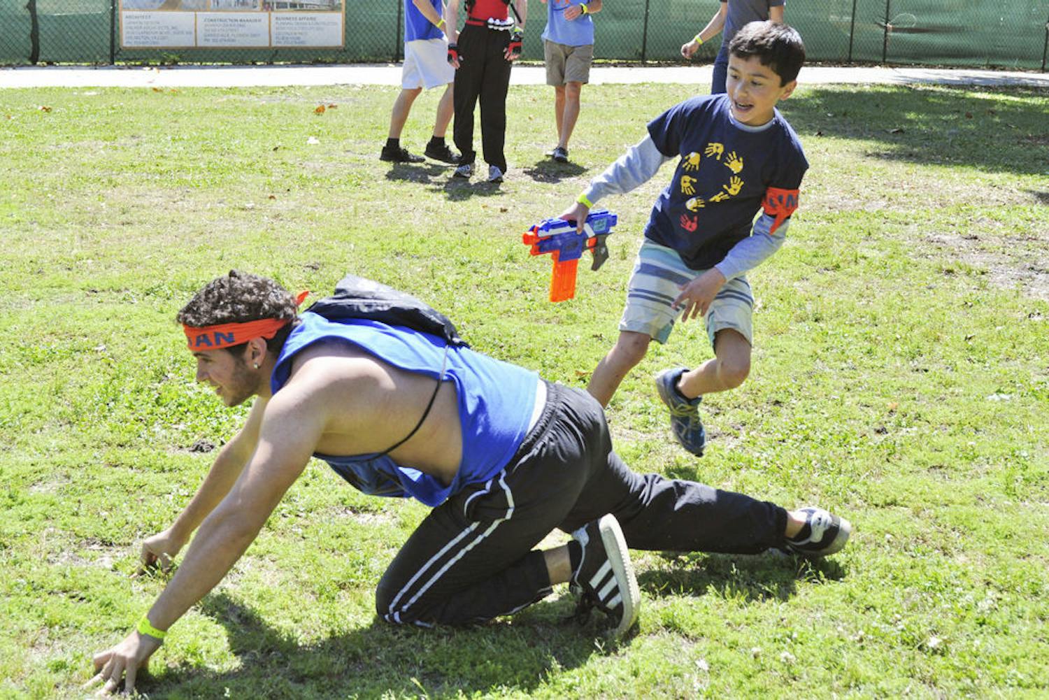 Nick Mullen, 12, chucks a sock at a zombie during a Humans vs. Zombies mini-mission for Children's Miracle Network Hospitals on the North Lawn on Saturday. Mullen was born with hypertrophic cardiomyopathy and has been treated at UF Health Children’s Hospital, where his mother, Jodi, is a pediatric nurse.